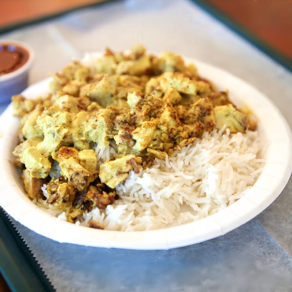 Hampton Chutney Co. chicken curry with white rice and a side of chutney.